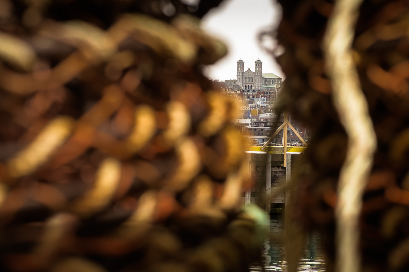 A View of the St. John's Basillica through a set of lobster pots - Southside Road
