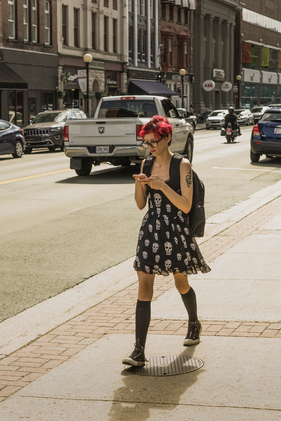 Skull dresses and chuck Taylor’s, texting while walking - water street 