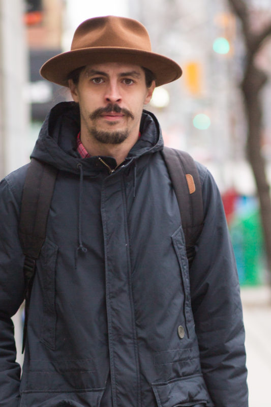 Chad was on his way to work at Goorin brothers Hat makers - his look is as serious as his hat is badass - Queen Street